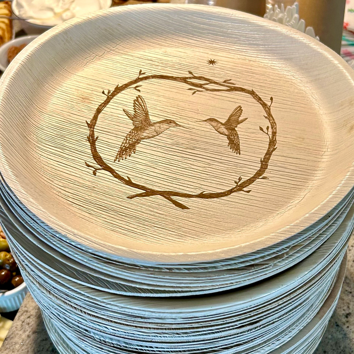 maaterra compostable palm leaf plates with Hummingbird Wreath on a table.