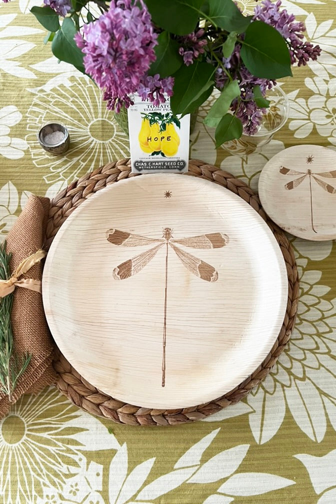 maaterra compostable plate with dragonfly design on a flower tablecloth