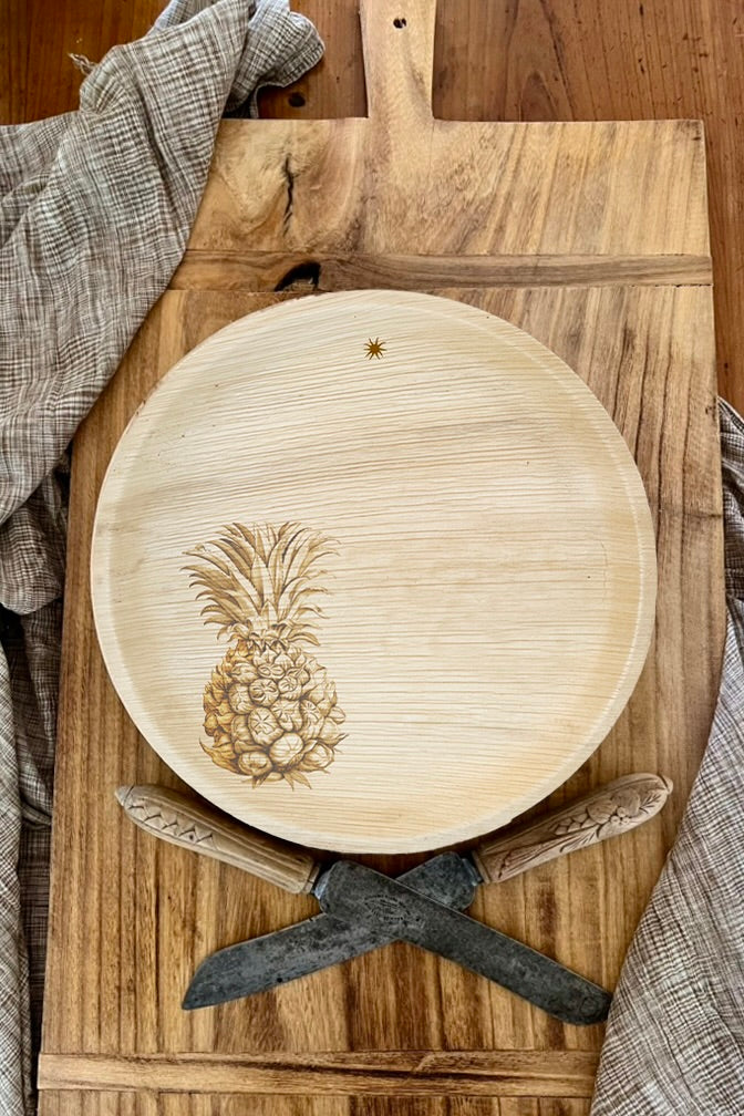 maaterra compostable plate with fresh pineapple design on a bread board