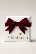 White gift box with a red velvet bow and 'maaterra' branding on a light gray background