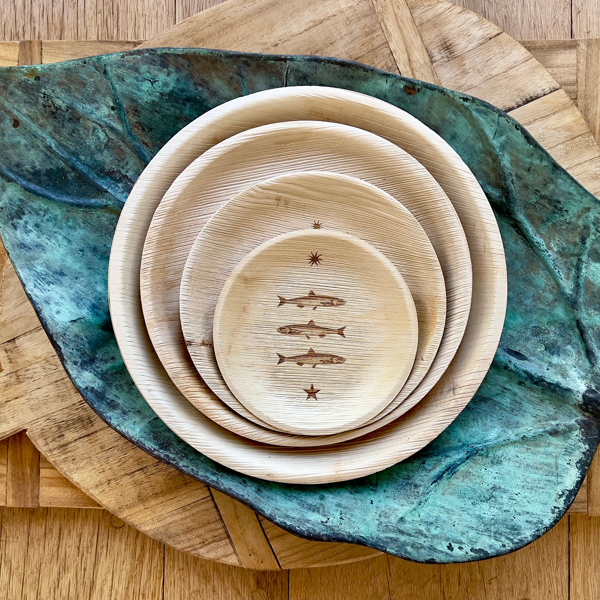 maaterra compostable palm leaf plate with stacked fish design.
