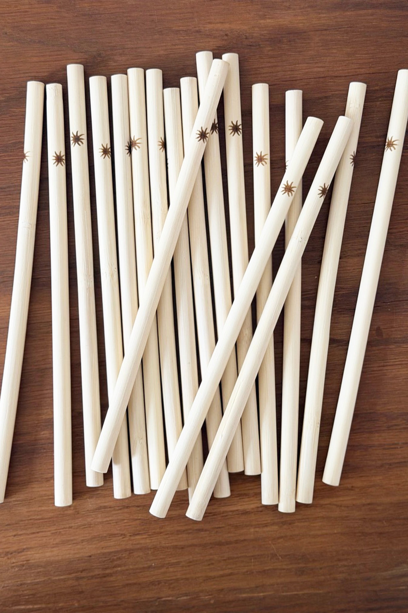 Bamboo straws with suns on a wooden surface