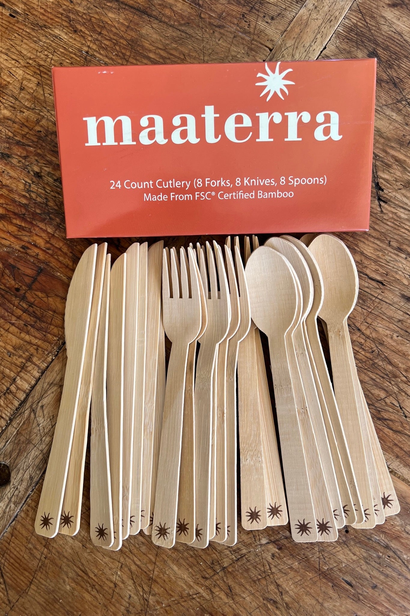Bamboo cutlery set with packaging displaying 'maaterra' brand on a wooden surface.