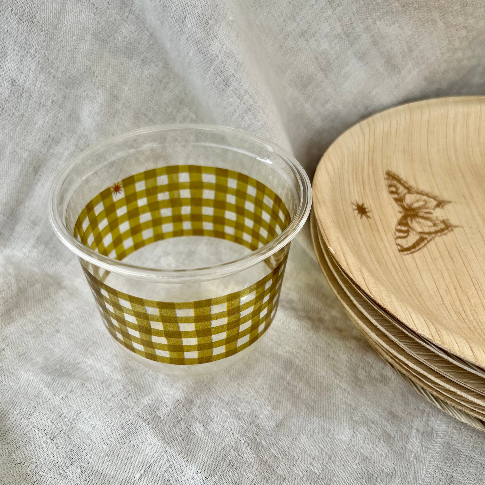 maaterra compostable cup with moss gingham design on a white table cloth