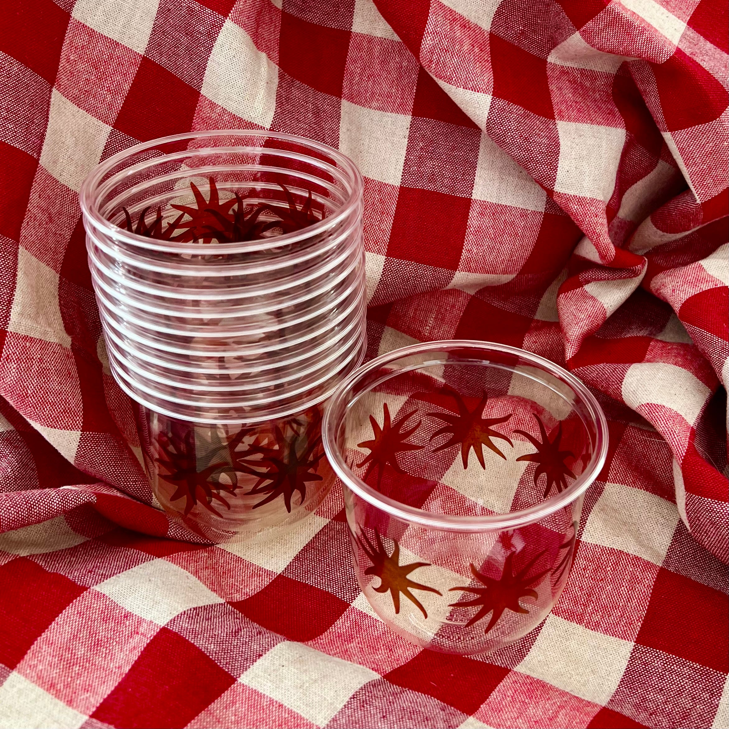 maaterra compostable cups with maaterra sun on a gingham tablecloth