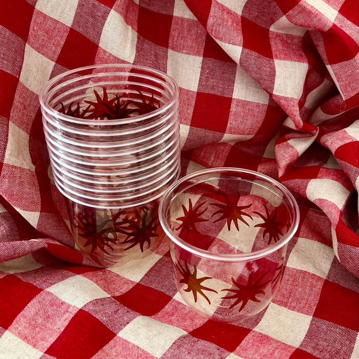 maaterra compostable cups with maaterra sun on a gingham tablecloth