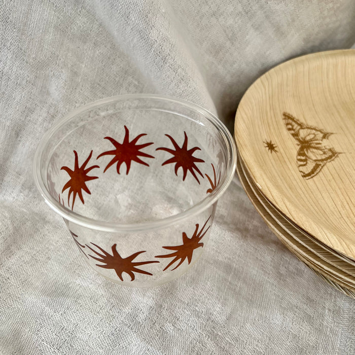 maaterra compostable cups with maaterra sun on a white tablecloth