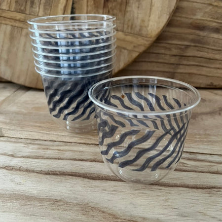 maaterra compostable cups with ocean waves design on a wooden table