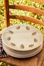 maaterra compostable palm leaf plate with block print wreath design on a chair outside