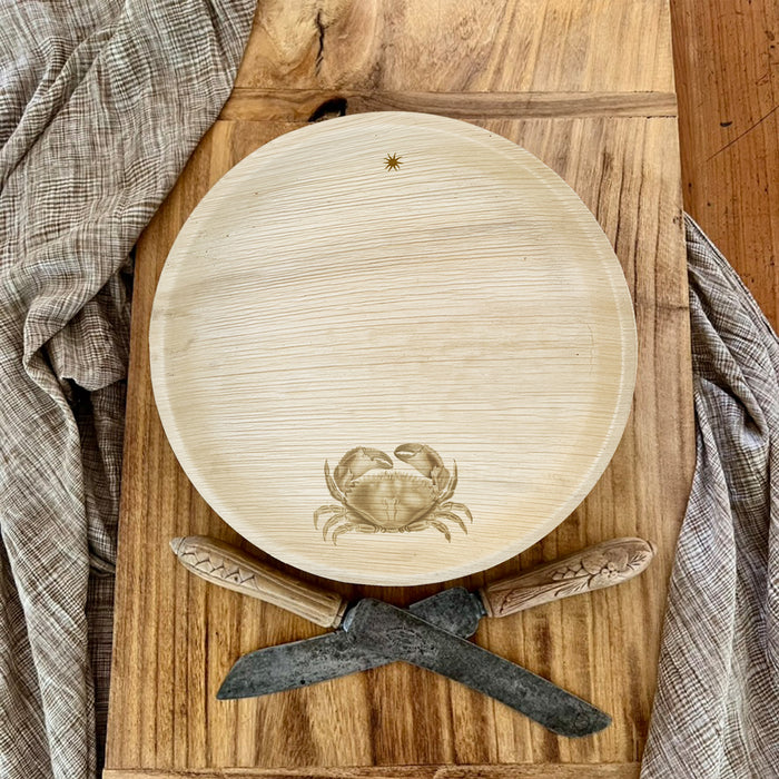 maaterra compostable palm leaf plate with crab design on a cutting board