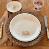 maaterra compostable palm leaf plate with crab design on a woven charger