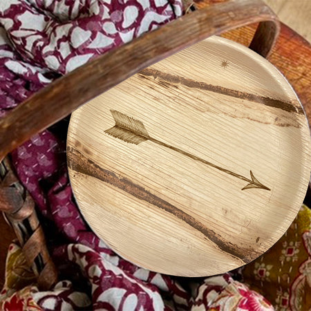 maaterra compostable palm leaf plate with single arrow design in a picnic basket