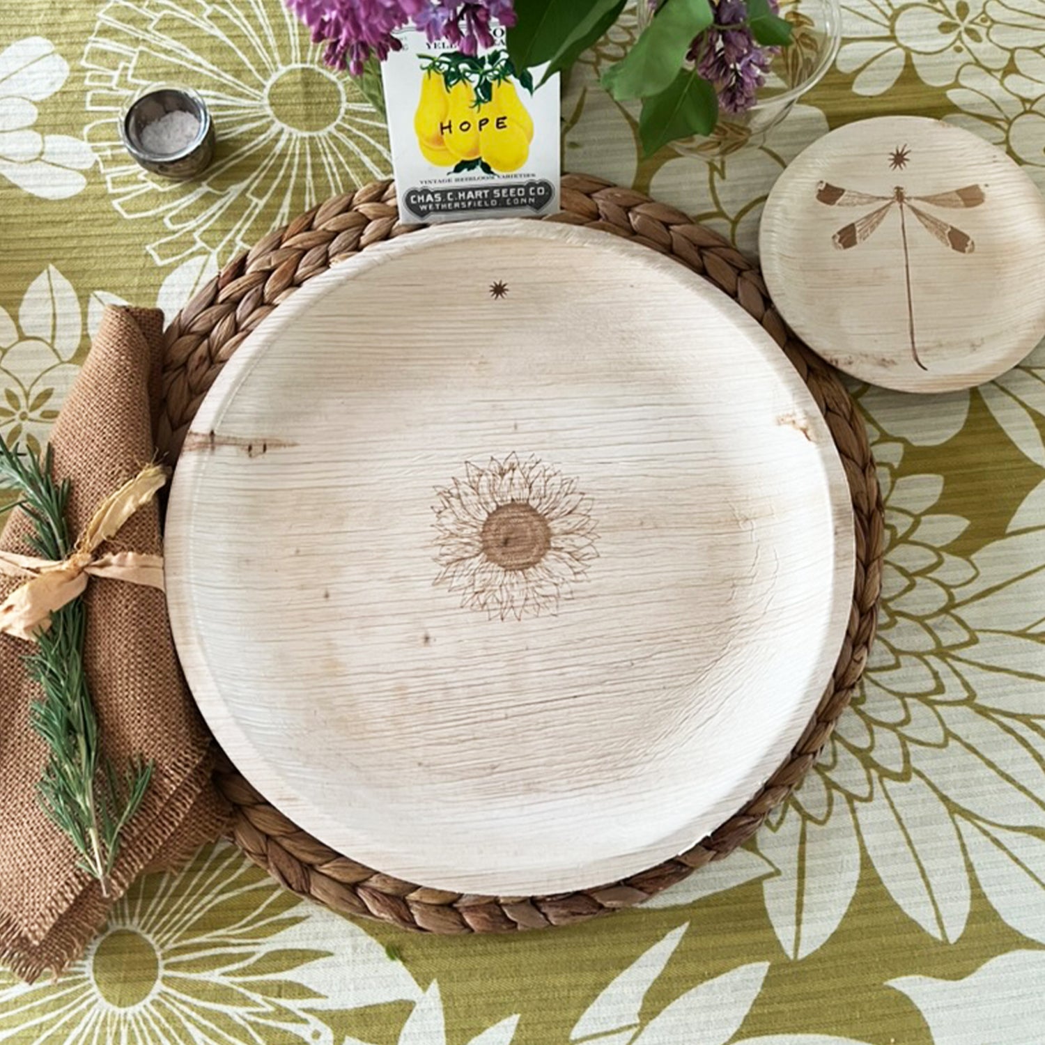 maaterra compostable palm leaf plate with sunflower design on a flower tablecloth