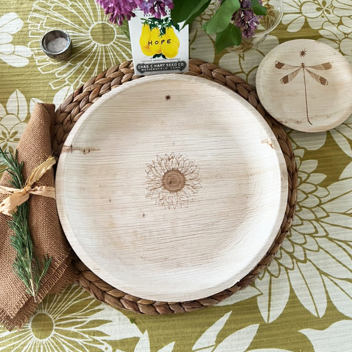 maaterra compostable palm leaf plate with sunflower design on a flower tablecloth