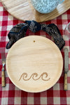 maaterra compostable palm leaf plate with waves design on a gingham tablecloth