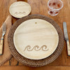 maaterra compostable palm leaf plate with waves design on a woven charger