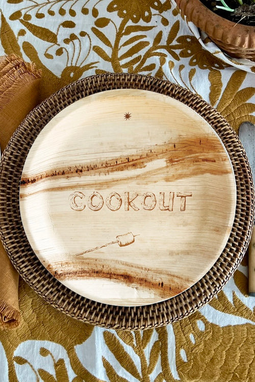 maaterra compostable plate with COOKOUT design on a woven charger
