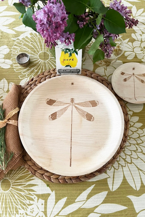 maaterra compostable plate with dragonfly design on a flower tablecloth