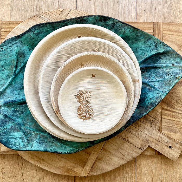 maaterra compostable plate with fresh pineapple design stacked on top of other maaterra plates