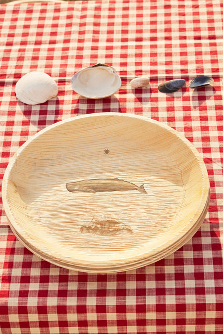 maaterra compostable plate with whale tale design on gingham tablecloth