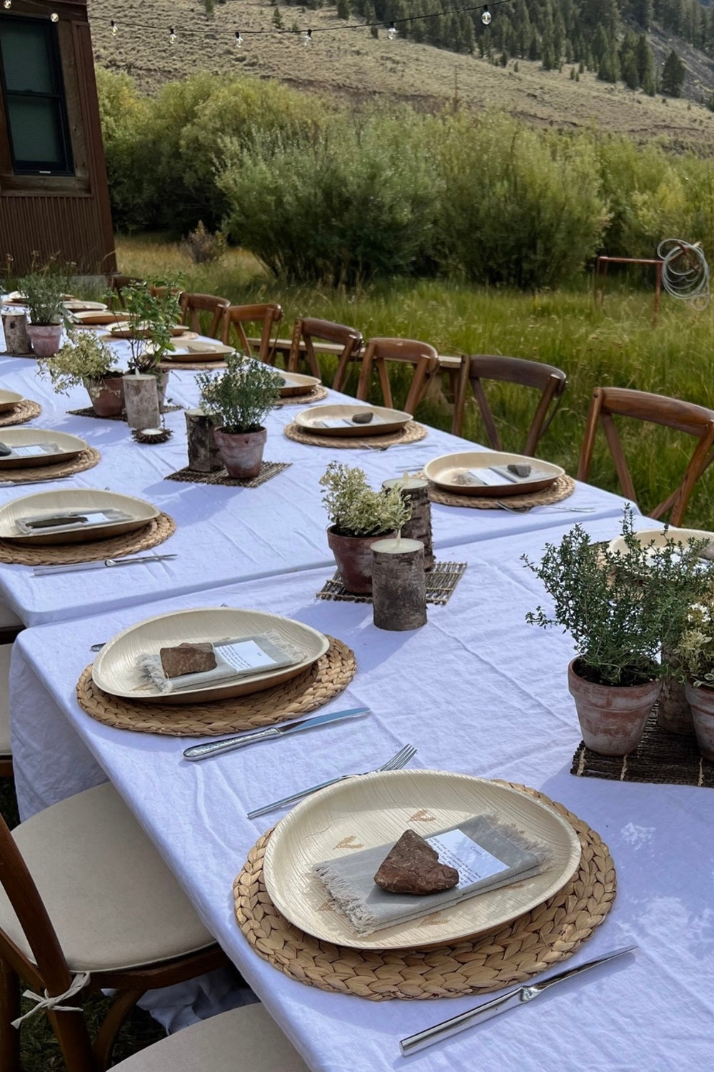 Wedding welcome party set with maaterra compostable plates with leaf heart design in a picturesque setting. 