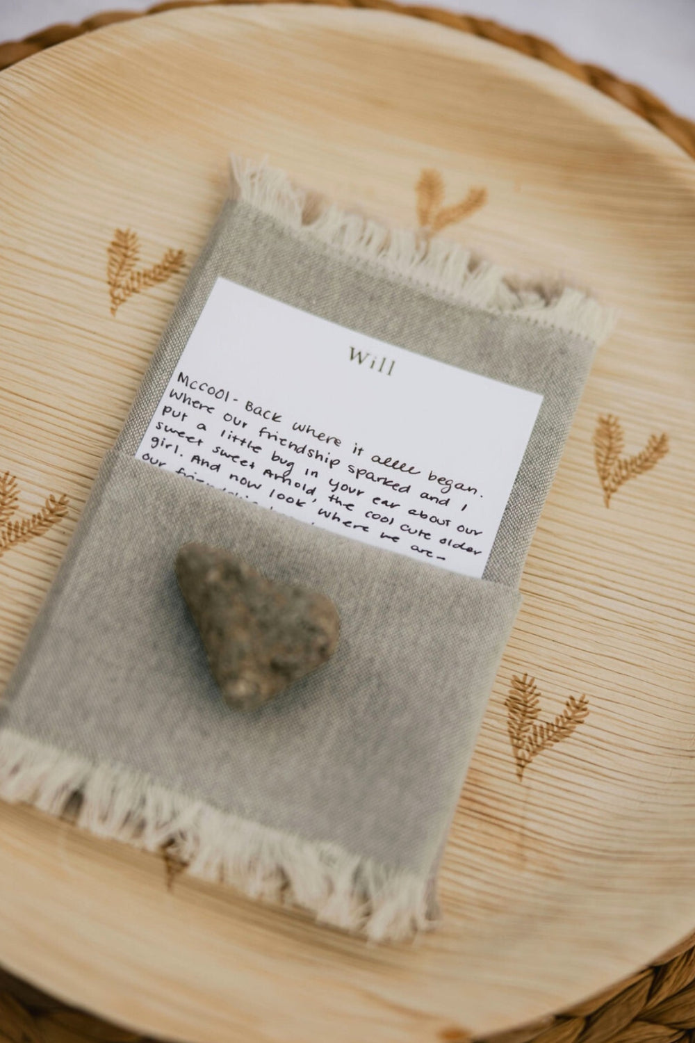 Love letter placed on top of maaterra compostable palm leaf plate with leaf heart design. 