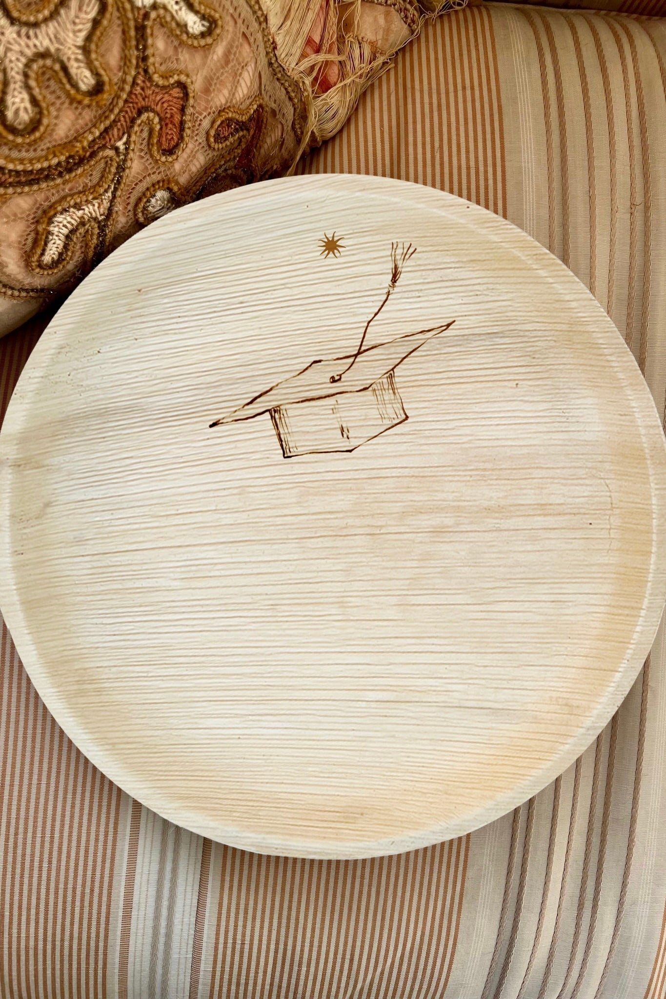 maaterra compostable plate with graduation cap design.