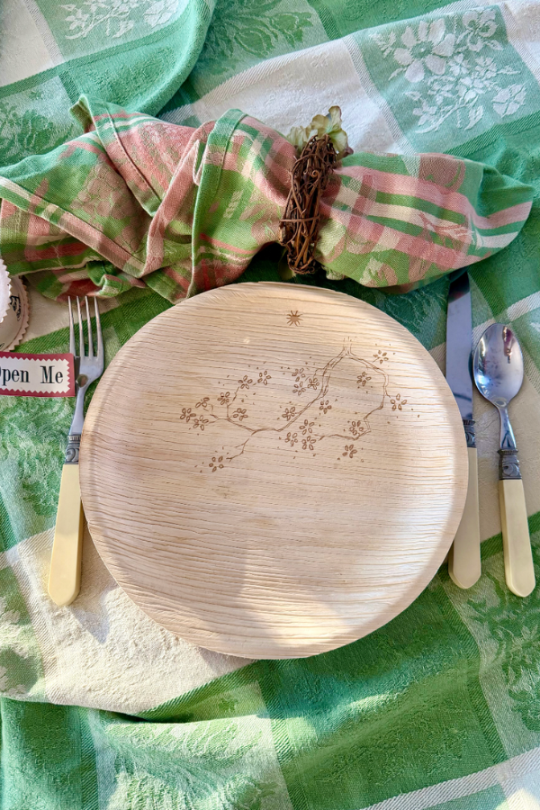 Palm leaf maaterra plate with snow in the summer design and summer themed table setting.