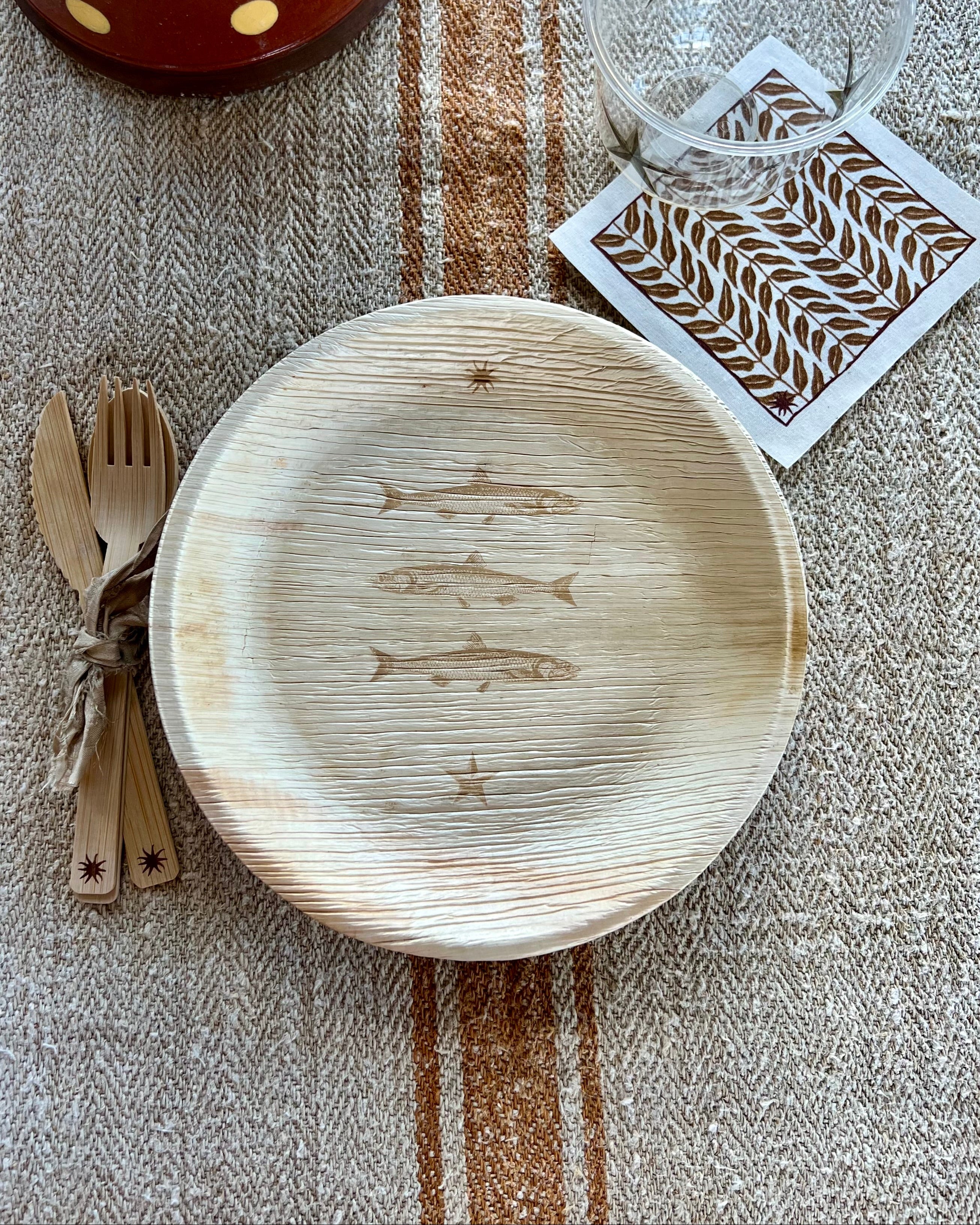 maaterra compostable palm leaf plate with stacked fish design.